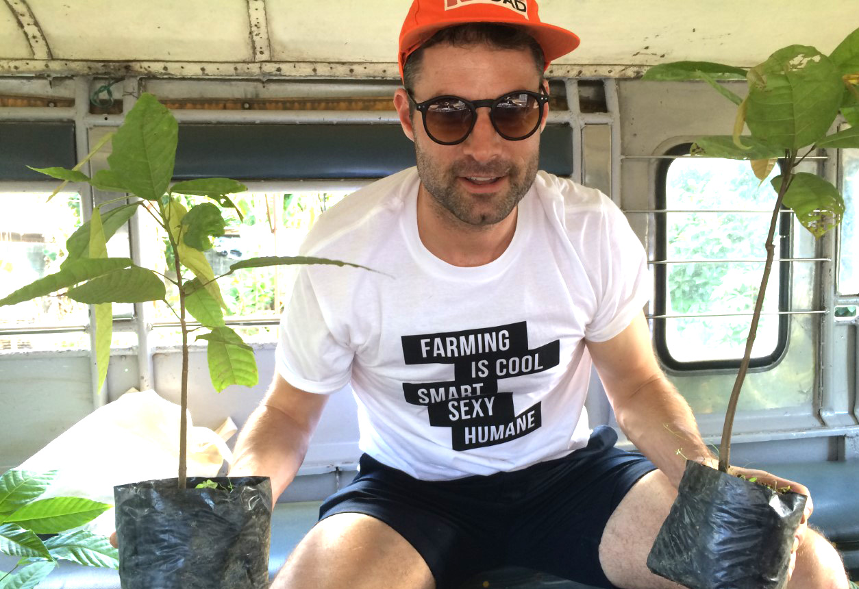 Roman holding two plants in the back of a jeep