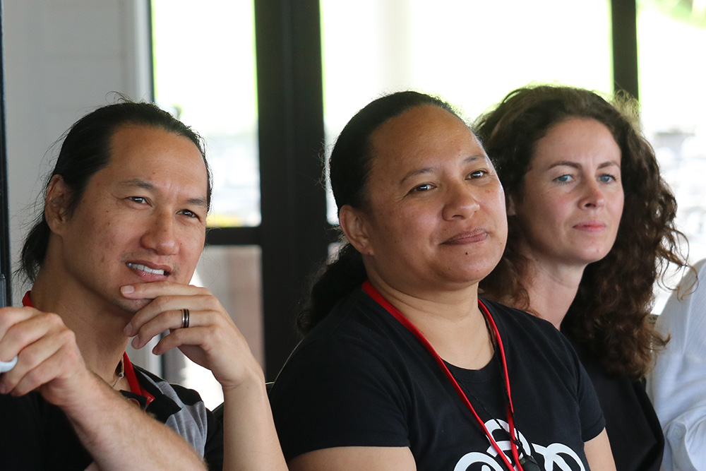 Three of the entrepreneurs listening to a speaker