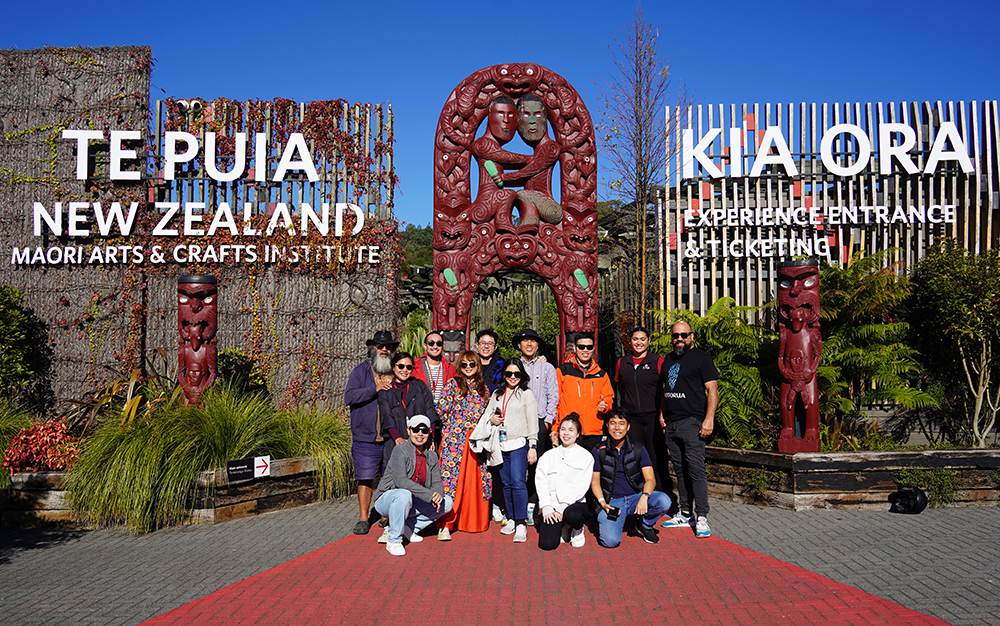 The entrepreneurs posing for a photo outside the gates of Te Puia Maori arts and crafts institute