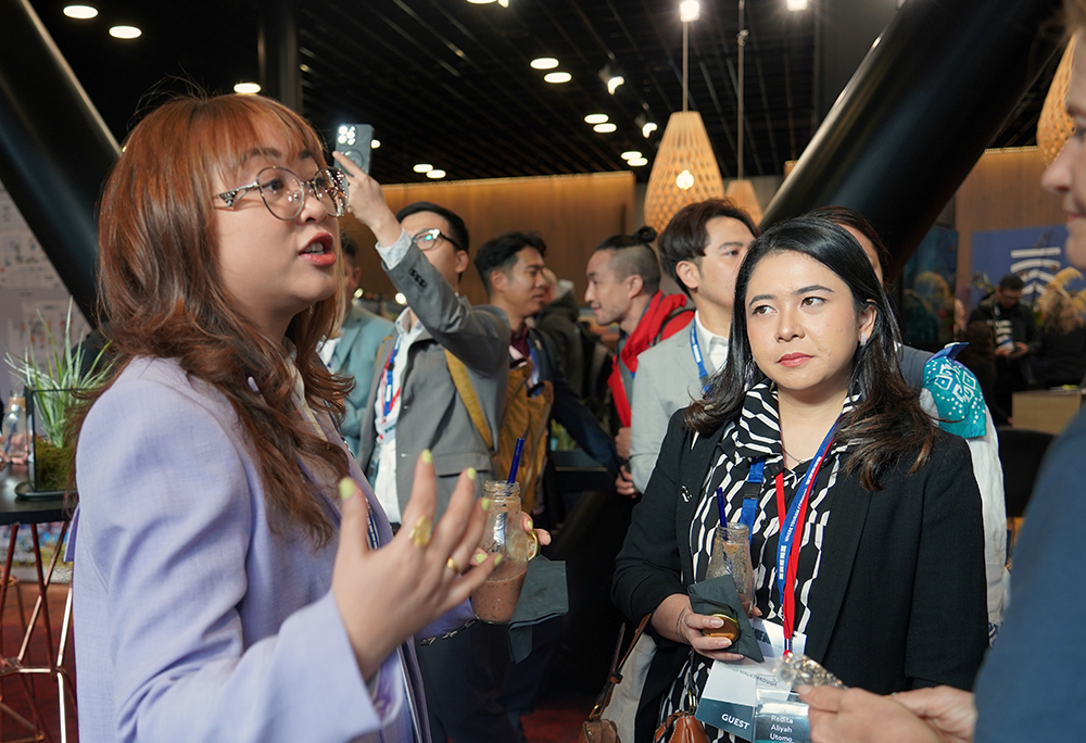 One of the entrepreneurs chatting to a man at a networking event