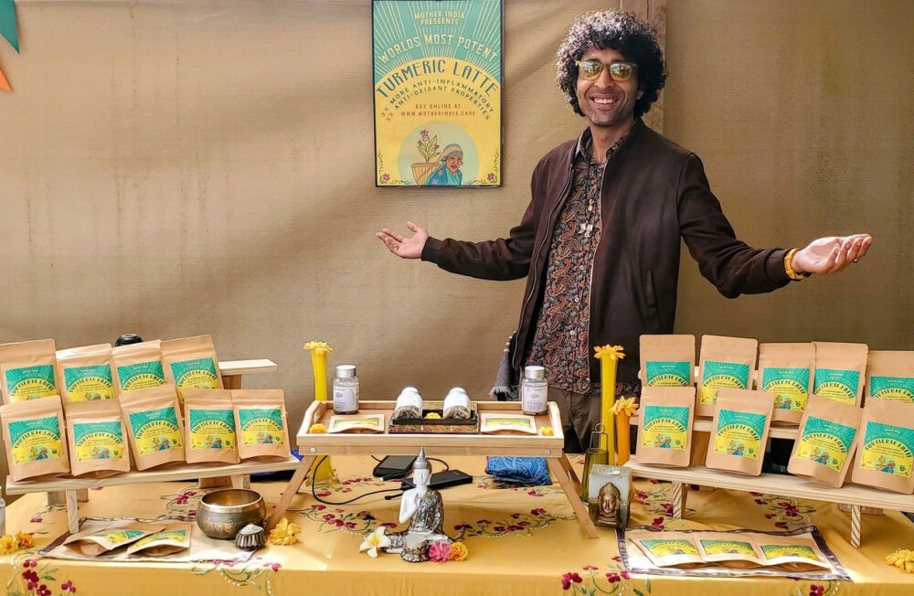 Vinny standing behind a display of his tumeric products