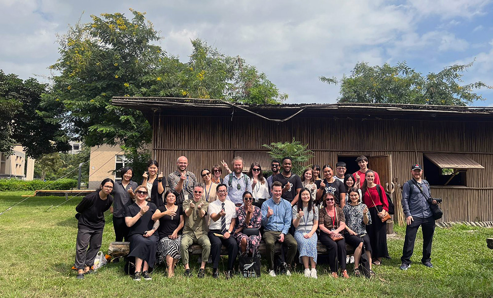 A group photo of Leadership Network members outide an indigenous house in Hualien, Taiwan
