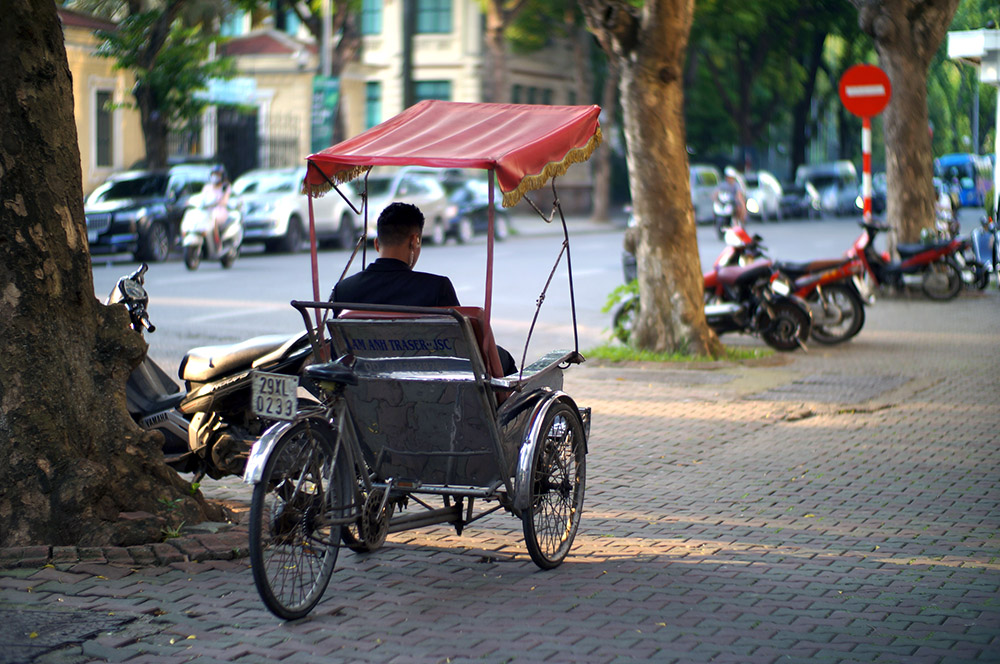 A man sitting in a rickshaw