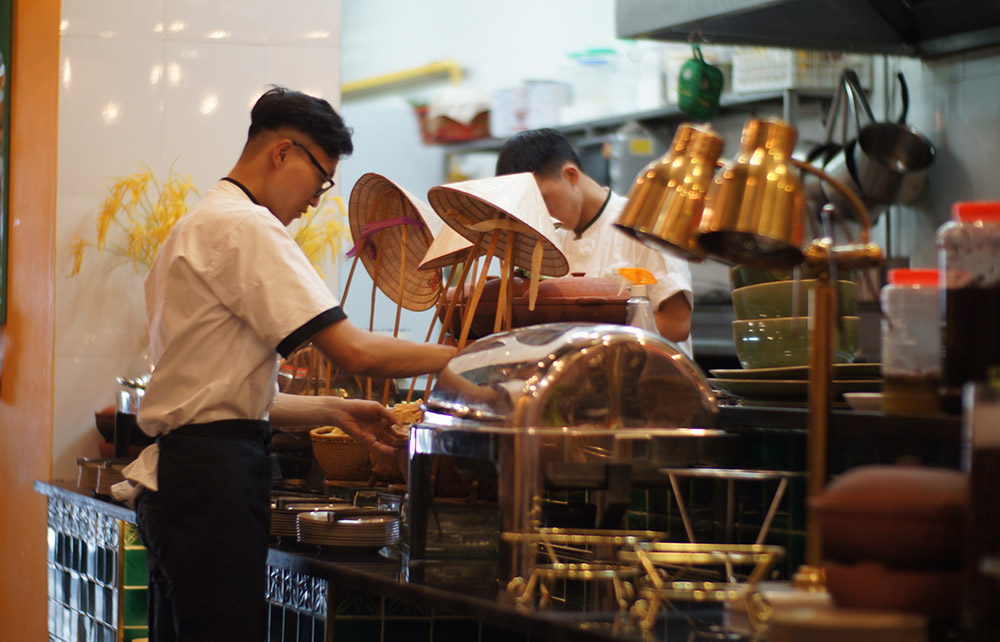 A waiter and a chef working in a restaurant
