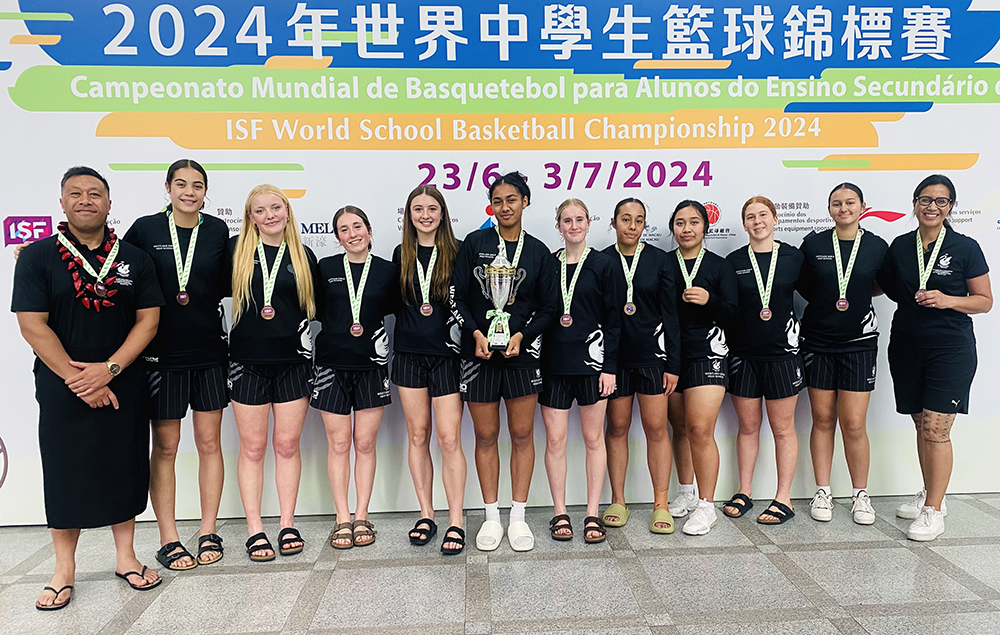 The team posing for a group photo with their bronze medals