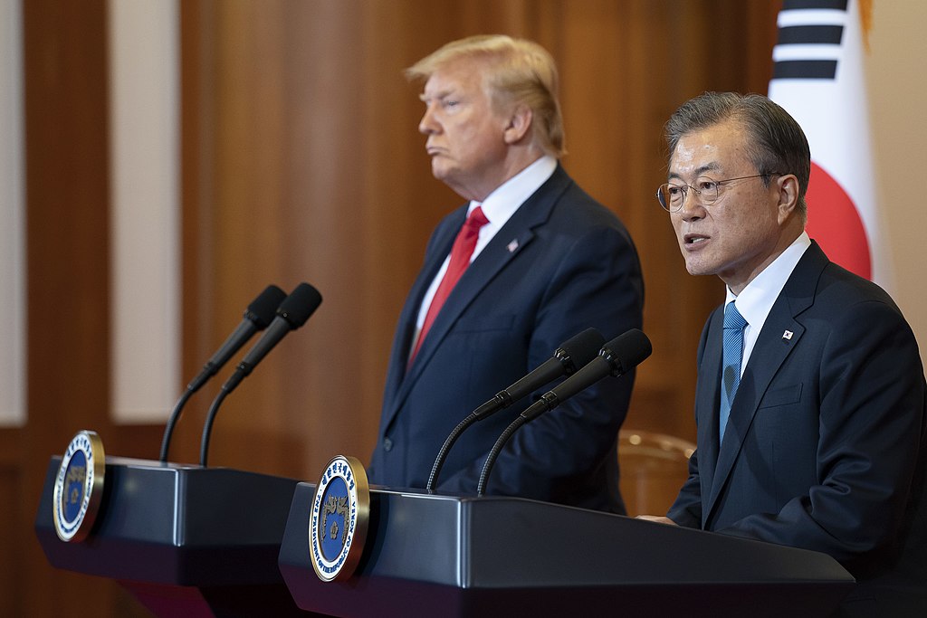 Donald Trump and former Republic of South Korea President Moon Jae-in standing at podiums as Moon Jae-in speaks