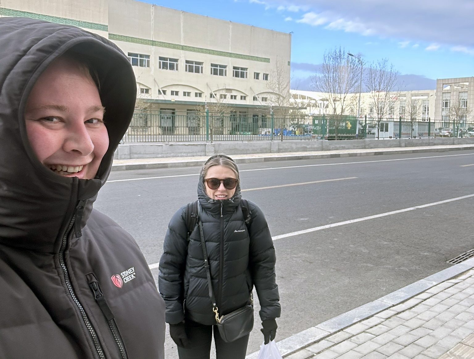 Brad and Millie on a Chinese street in thick winter jackets