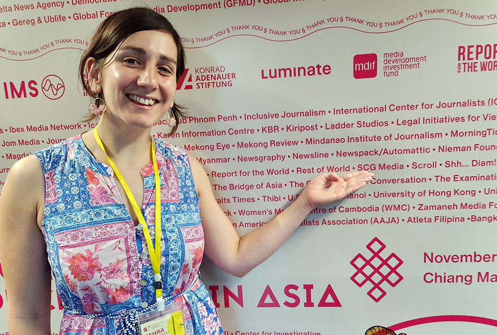 Article author Zahra Shatahmasebi pointing to a Splice Beta poster