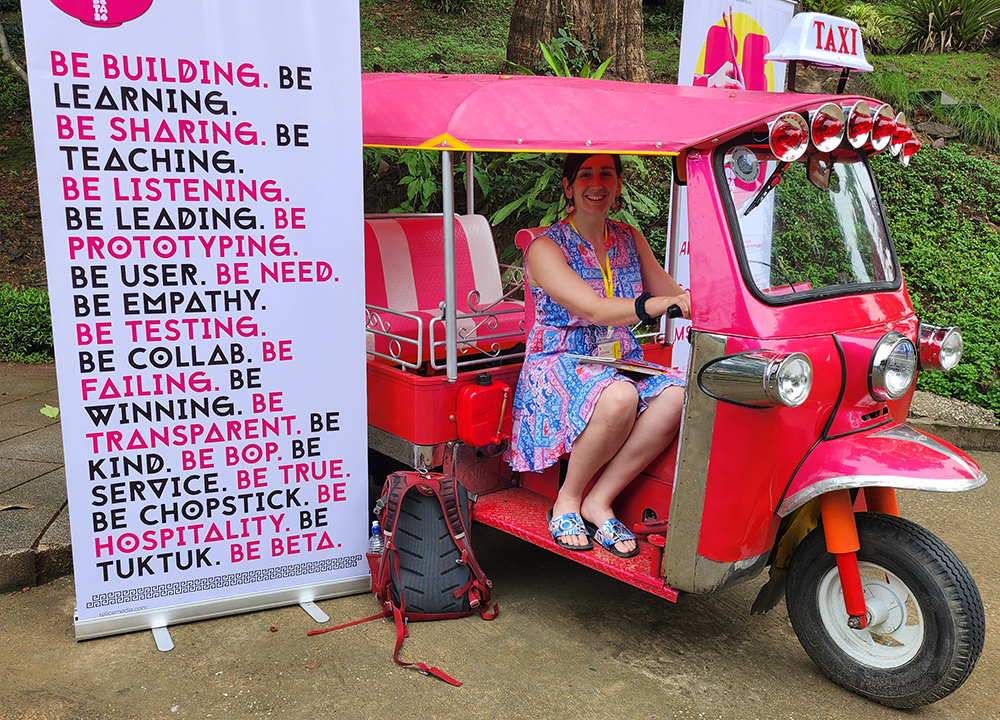 Article author Zahra Shatahmasebi  sitting in a pink tuk-tuk