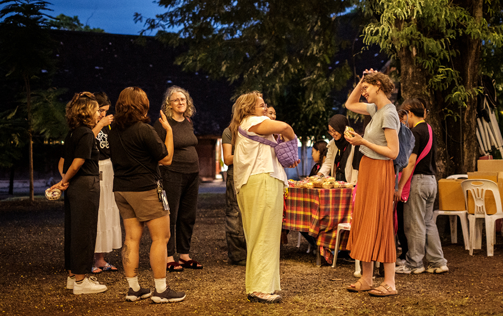 The NZ delegation socialising in the evening outdoors