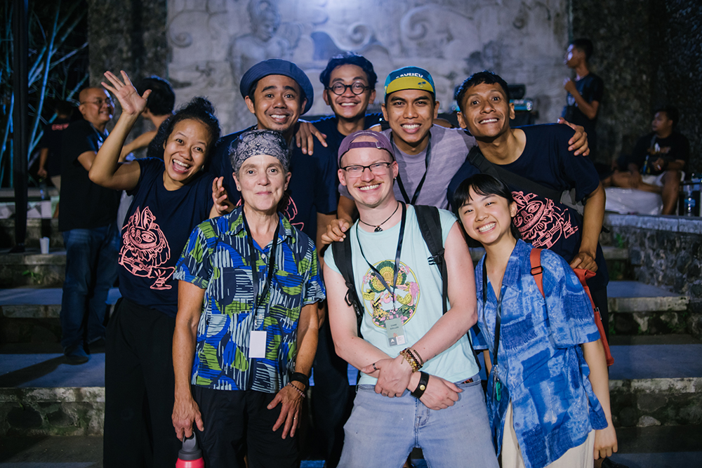 A group of eight people, including Talia, posinbg for a group photo