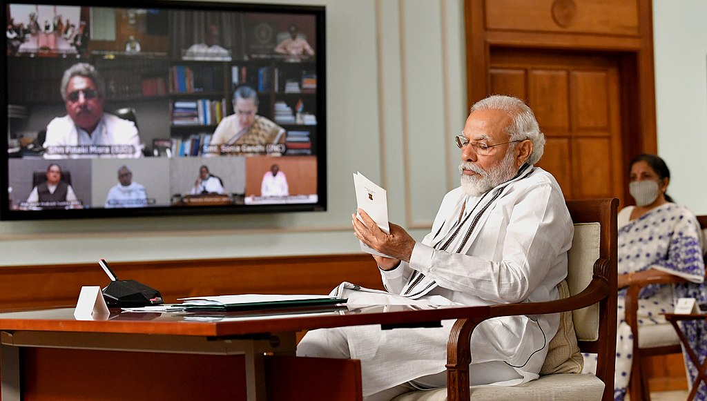 Indian Prime Minister Modi reading a document during an online conference
