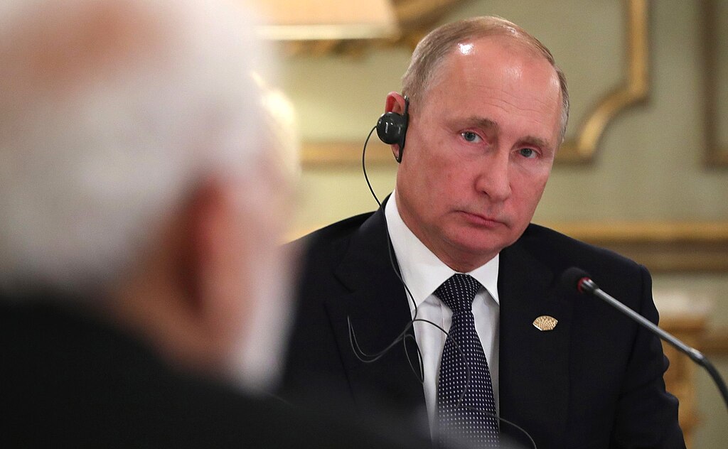 Russian President Putin wearing a headset and looking at Modi