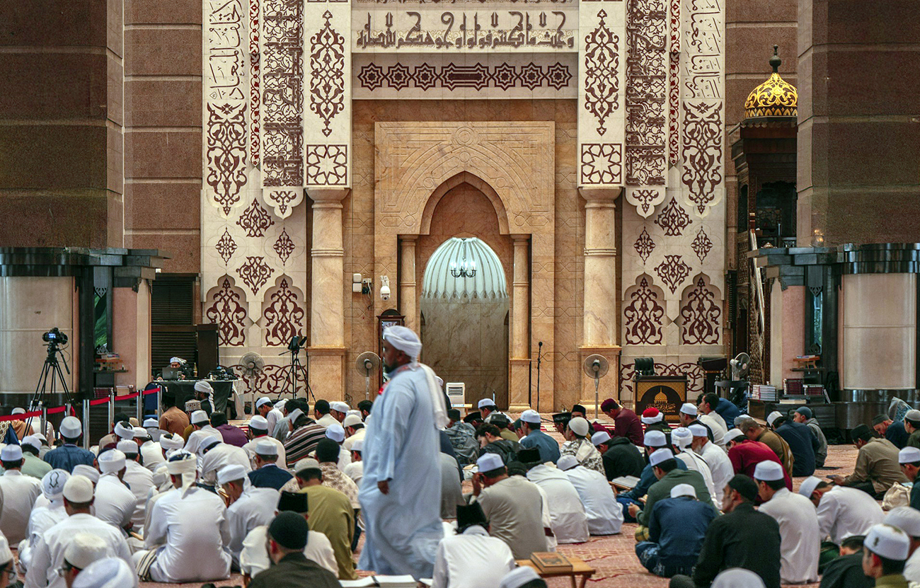 Men sit for ptayer in a mosque