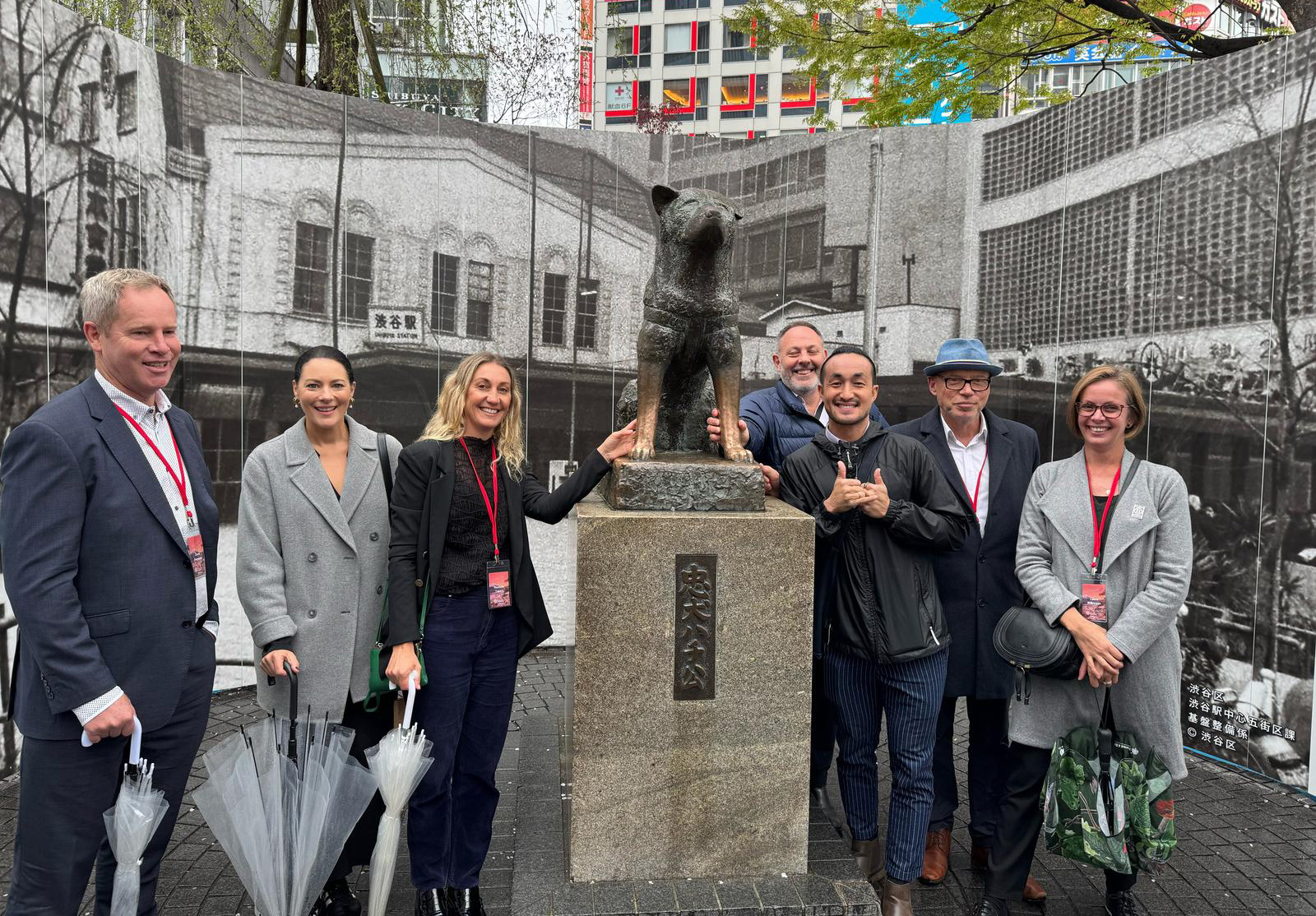 The delagation of pet industry entrepreneurs posing beside the statue of Tokyo's most famous dog, Hachiko