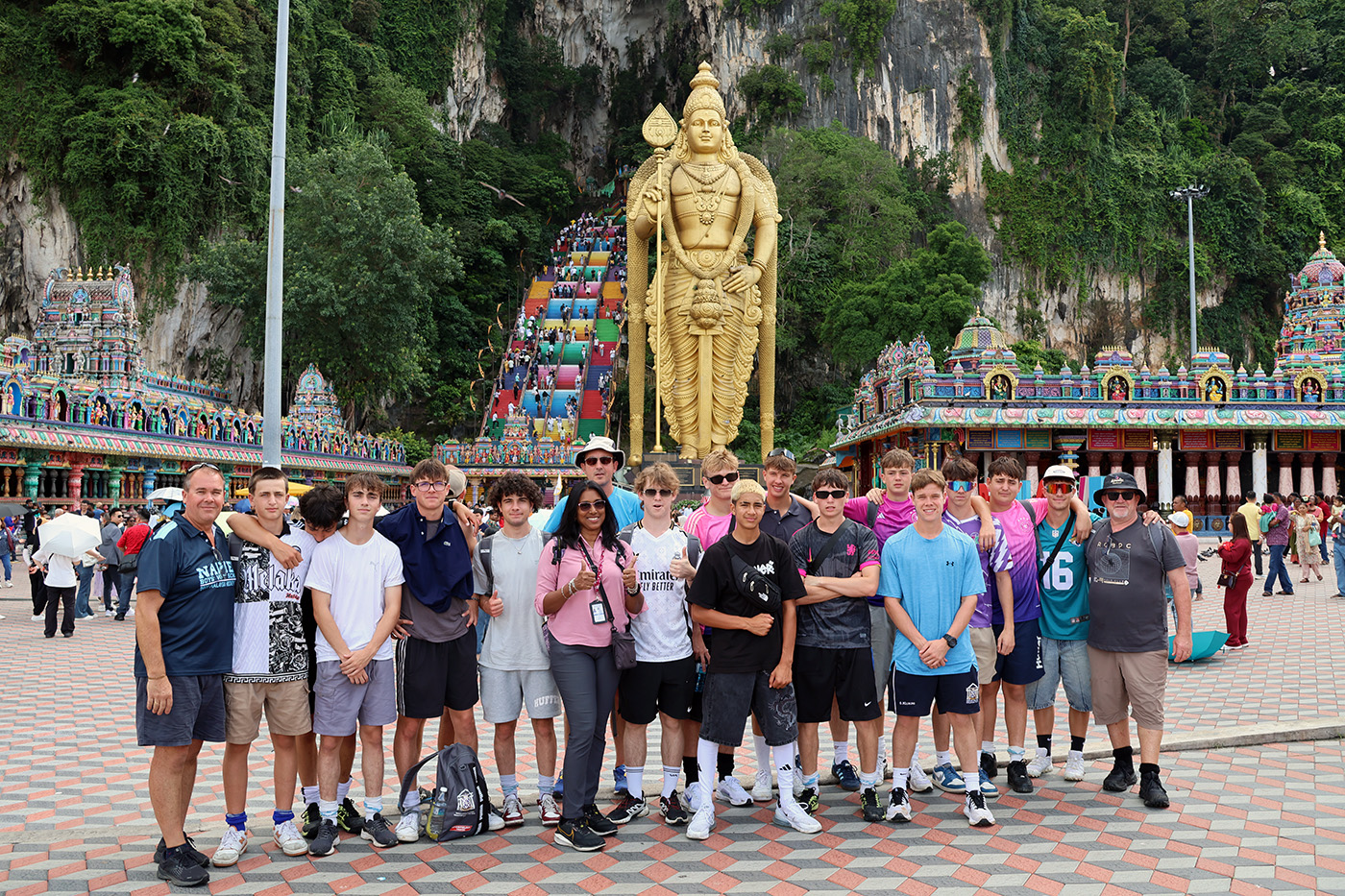 The team standing at the foot of the colourful stairs that lead up to the Batu Caves just outside of Kuala Lumpur