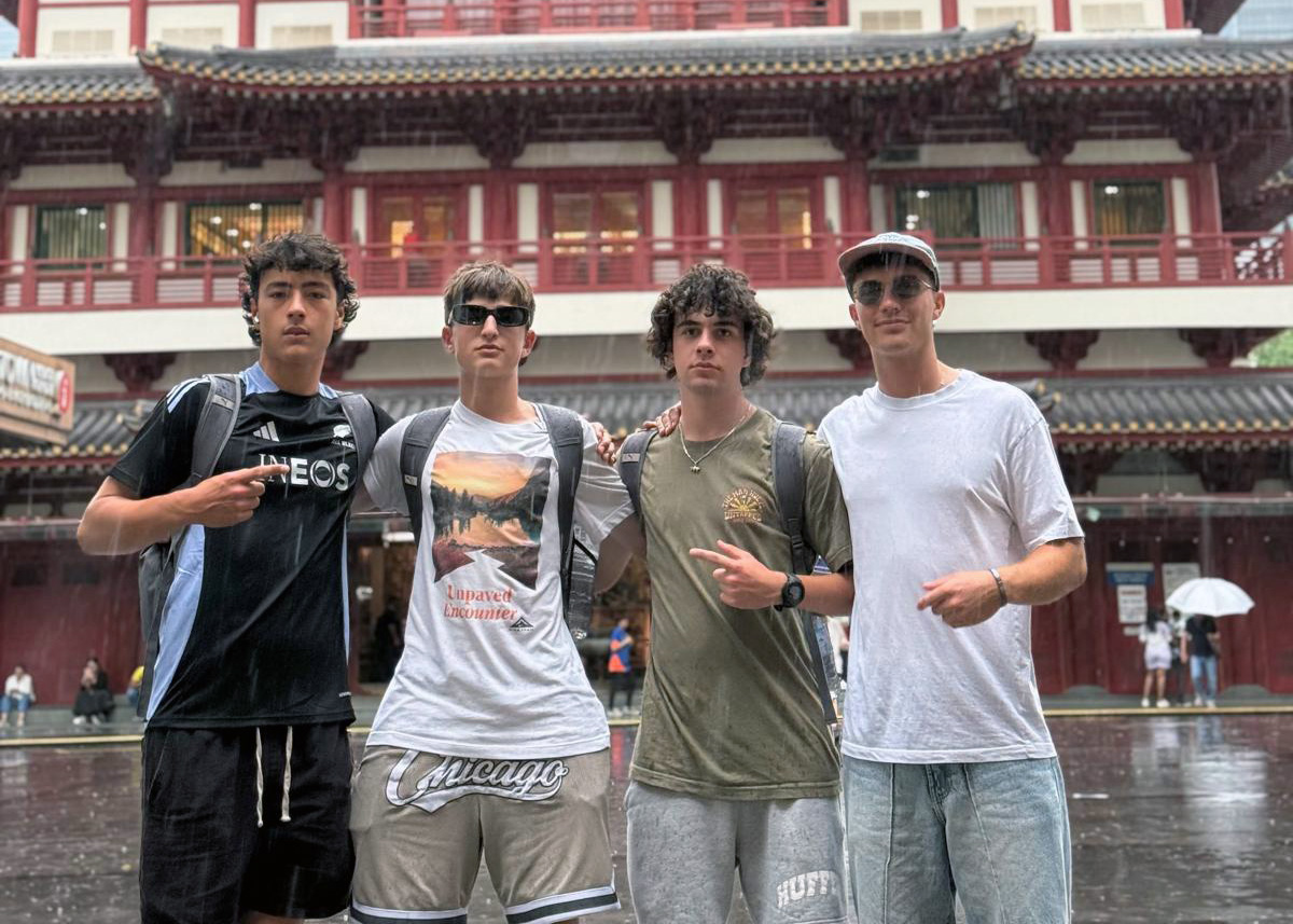 Four of the team posing in front of a traditional Chinese-style building