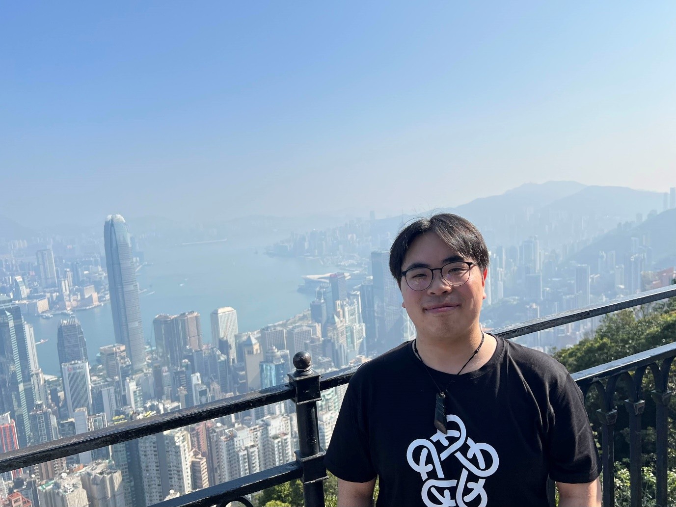 Ryan at Victoria Peak with Hong Kong and Victoria Harbour behind him