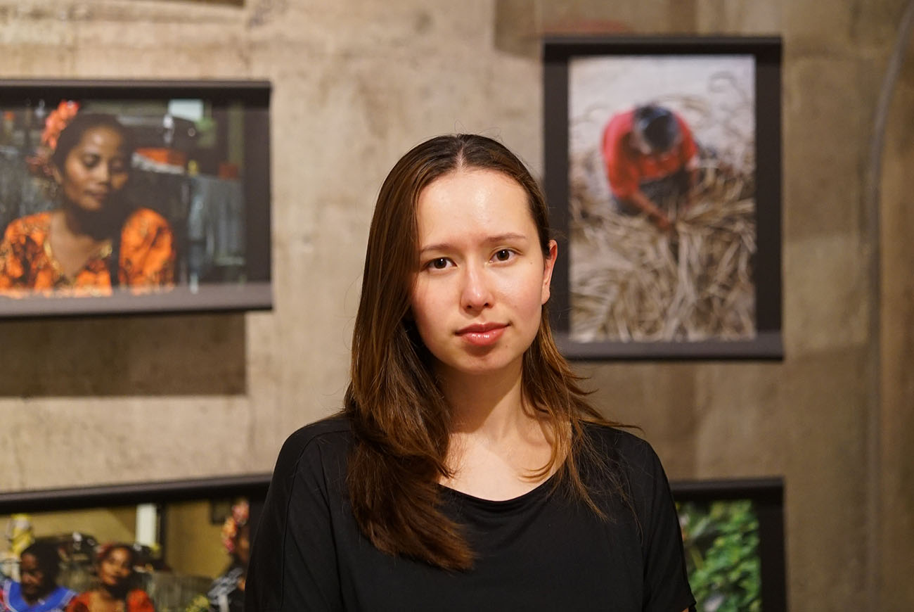 a portrait image of Katrja infront of a photo wall