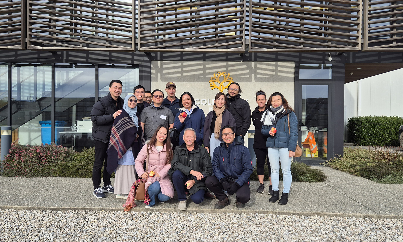 The entrepreneurs posing for a photo in front of a building