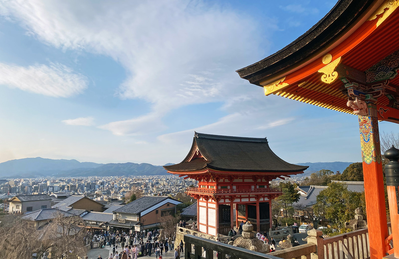 looking out across a Japanese city with the rooftop of a temple in the foreground