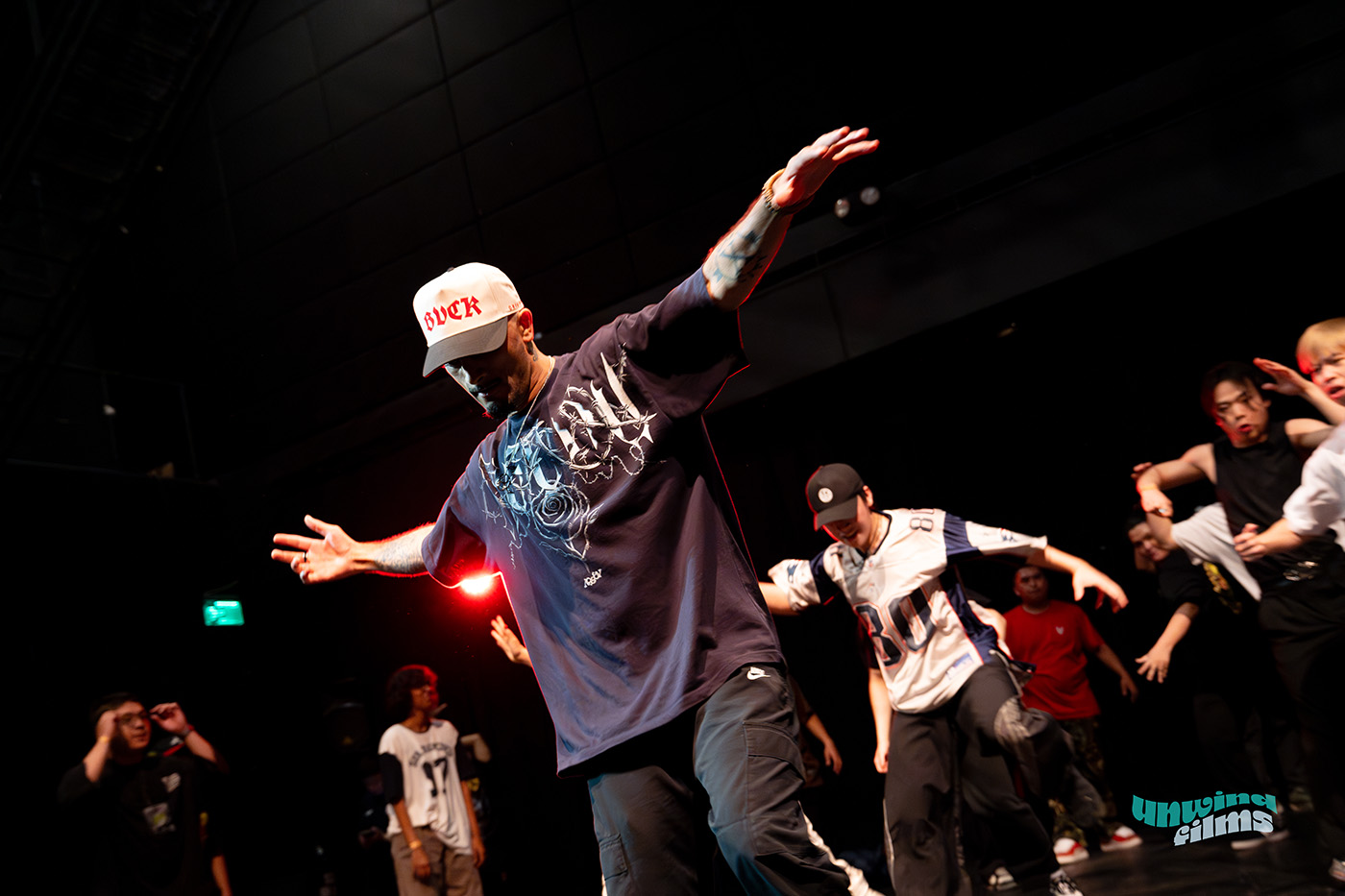 Trenten practicing moves with a group behind him doing the same