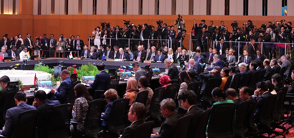 The 15th East Asia Summit (EAS) Foreign Ministers’ Meeting sitting in a large conference room watched on by media