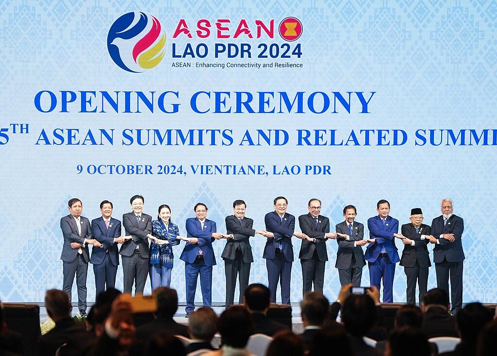 12 ASEAN leaders on stage linking hands