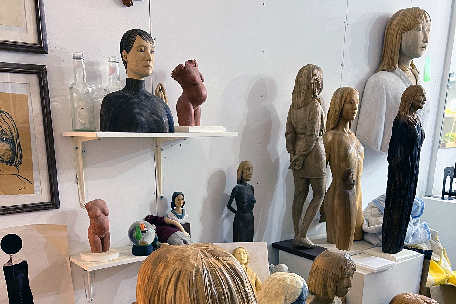 Wooden sculptues of people on shelves