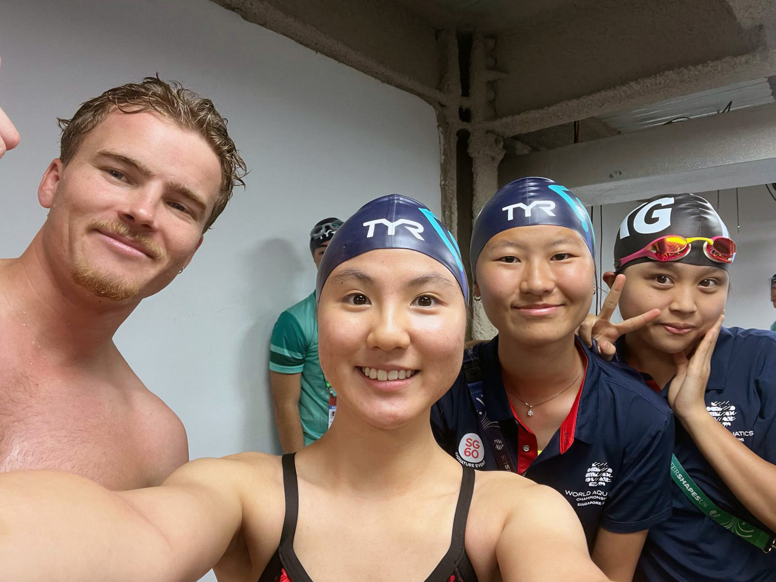 Connor posing for a selfie with three swimmers