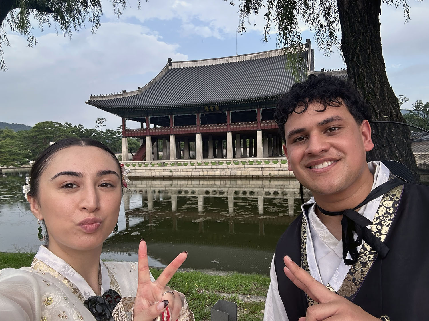 Intern Rīpeka Raihania fellow CJ Cultural Foundation intern Toosavili Tuatagaloa dressed in traditional Korean clothes and standing in front of traditional Korean building