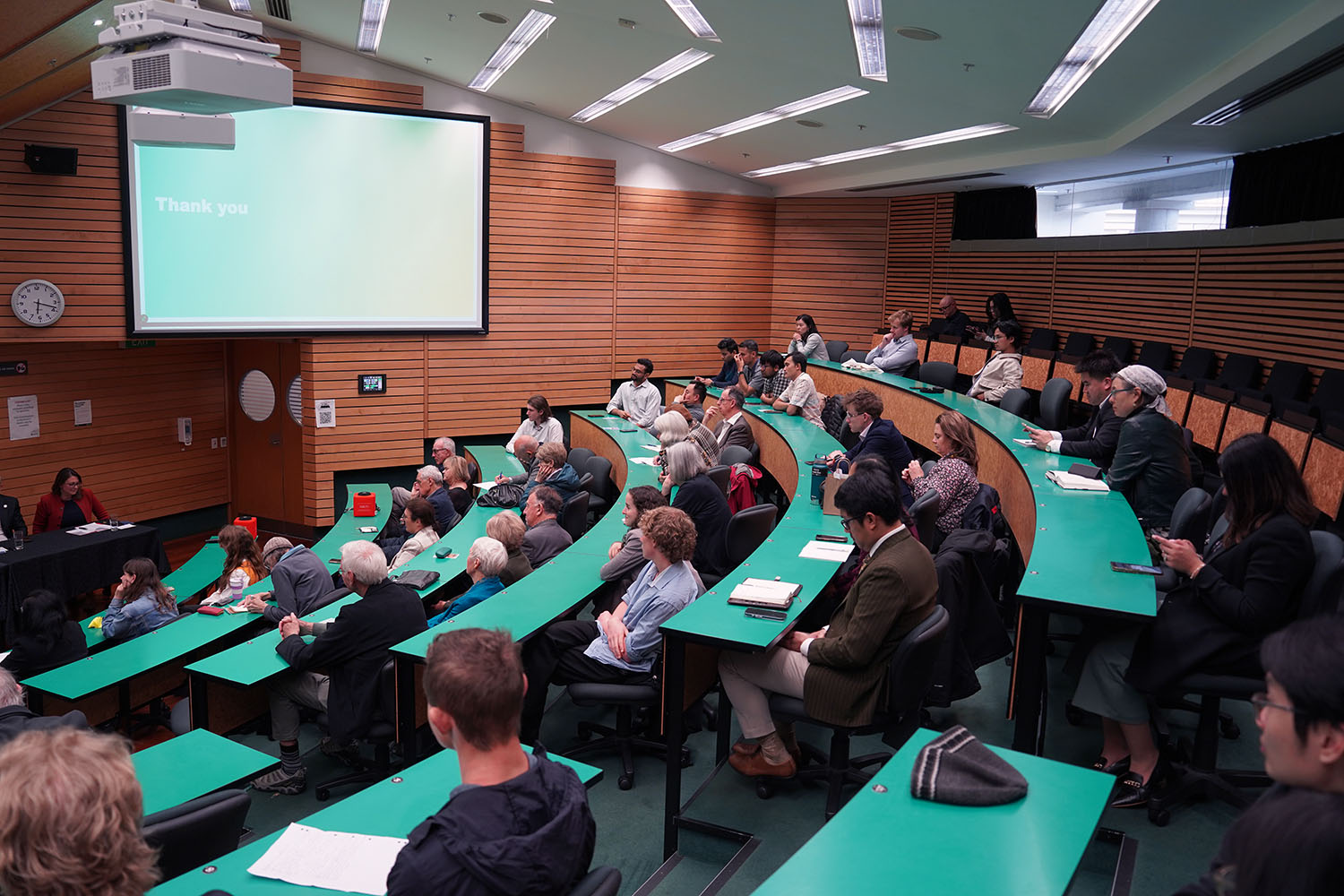five rows of people sitting in auditorium