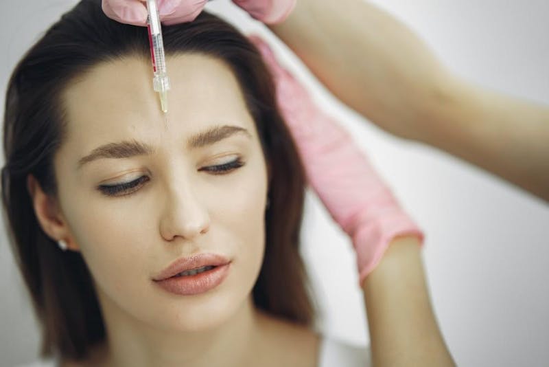 woman getting BOTOX in forehead