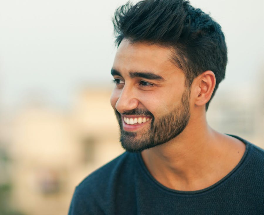 man smiling and looking to the side