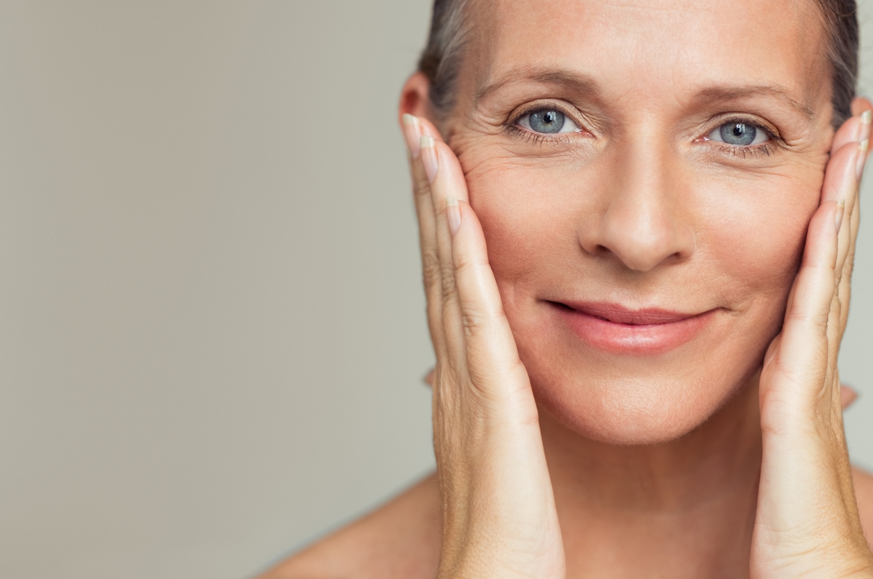 woman touching the sides of her face