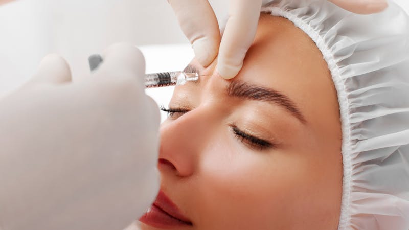 woman getting injections for 11s near eyes