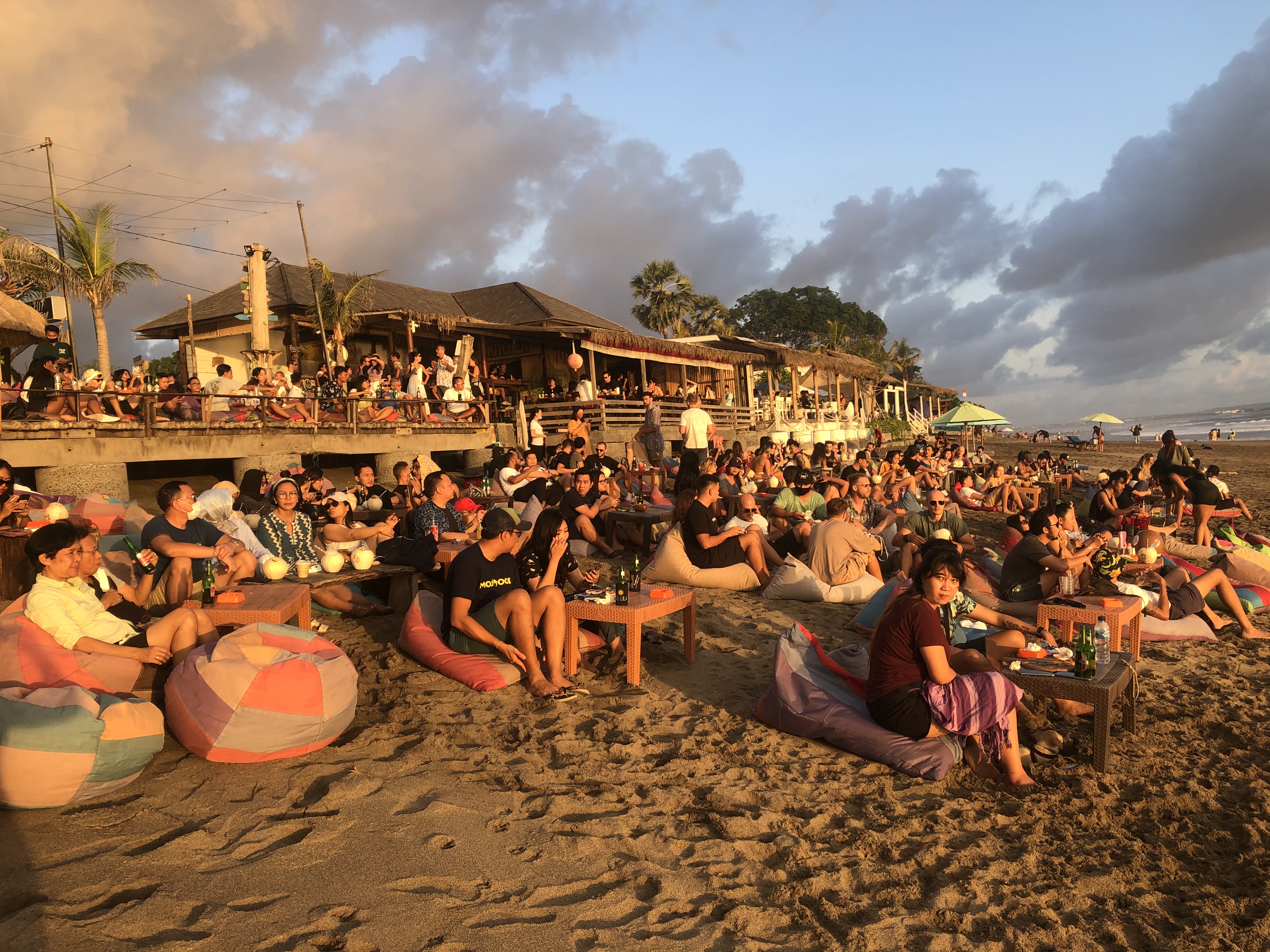 Life is returning to normal in Bali and sunset crowds have returned to Seminyak Beach