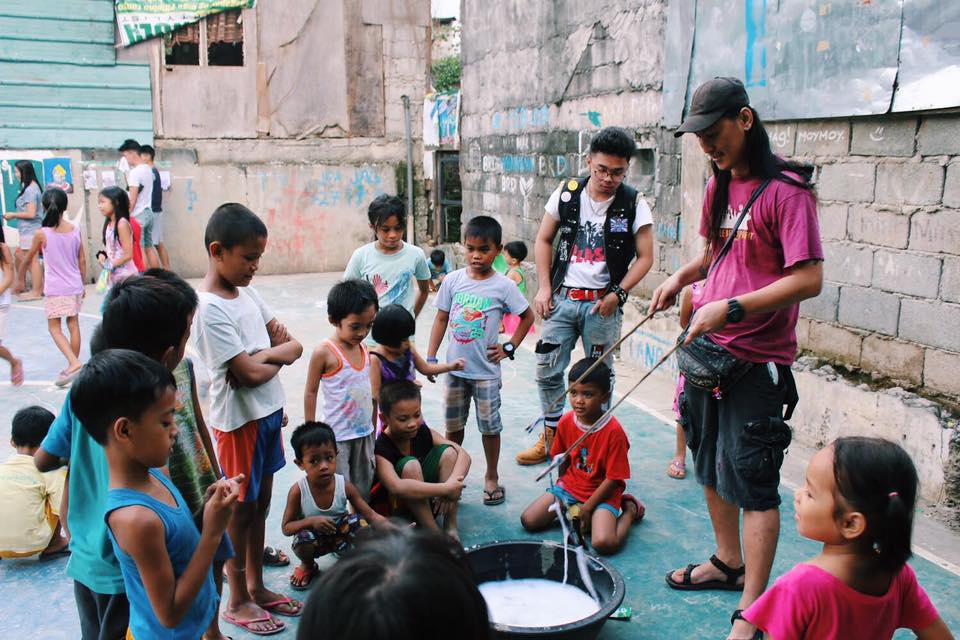 Political activists entertain kids at a slum in Santolan