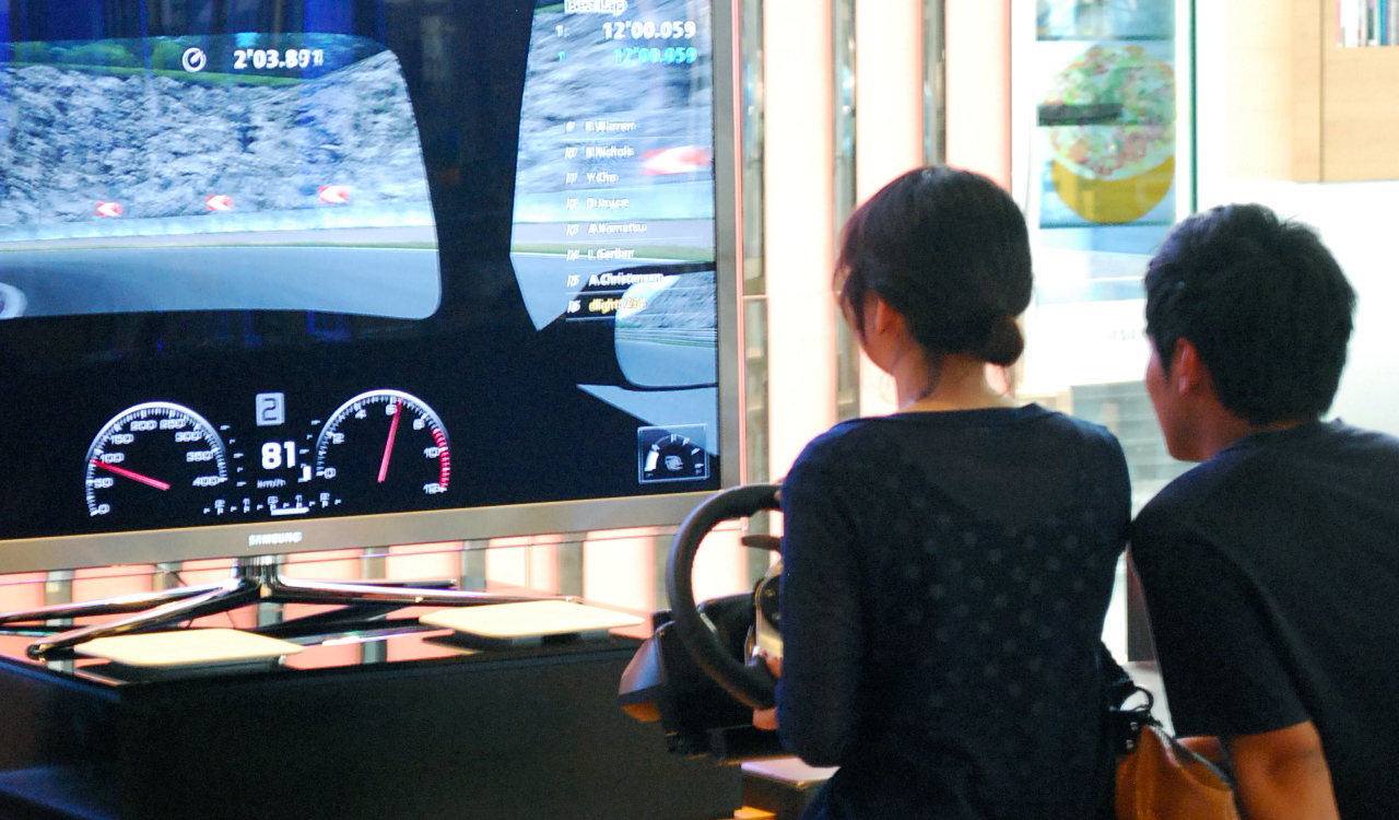 Woman playing game at arcade