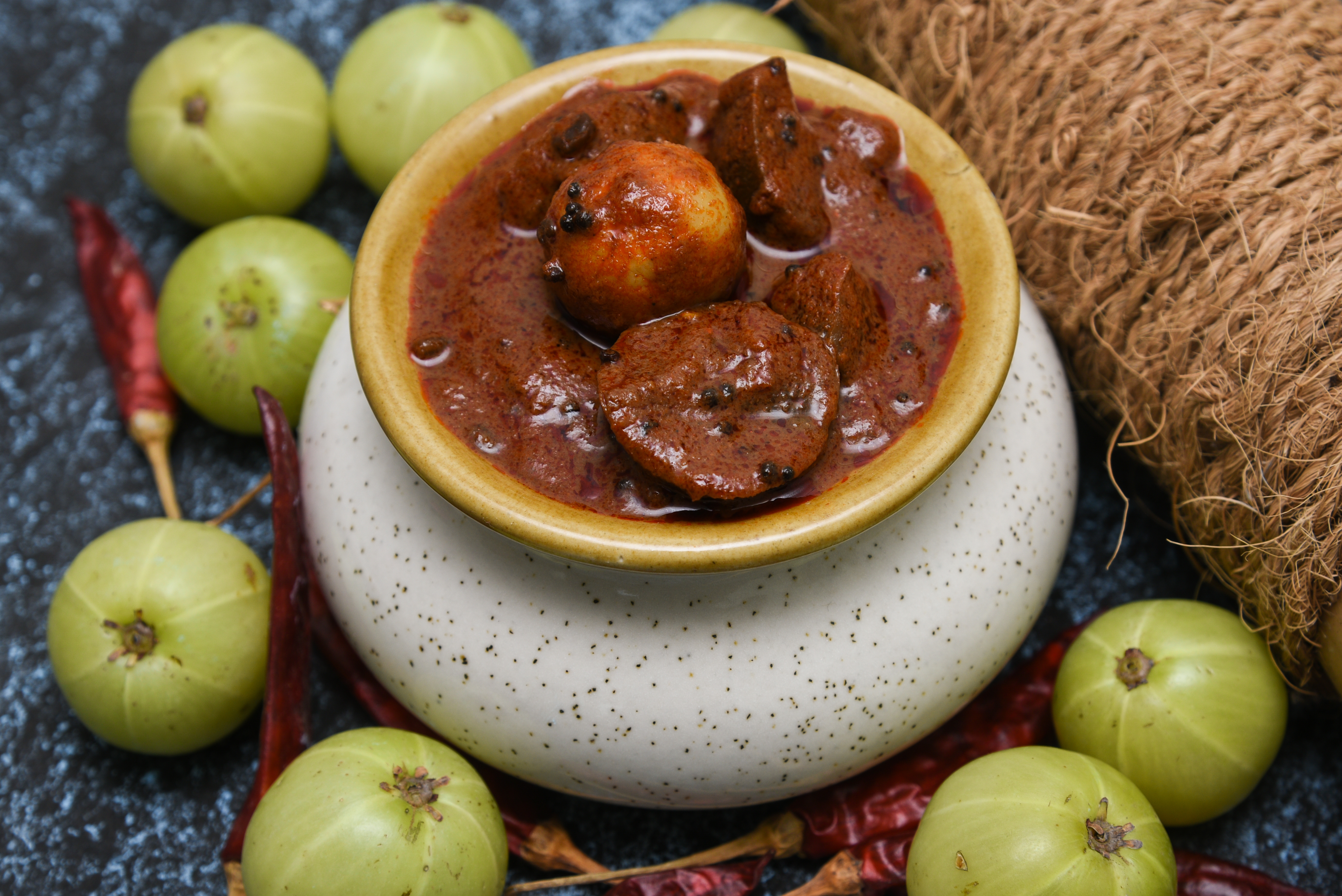 A gooseberry pickle in a ceramic jar.