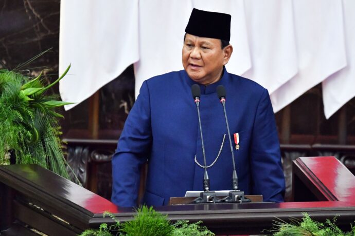 Indonesian president Prabowo Subianto stands behind a podium about to deliver a speech