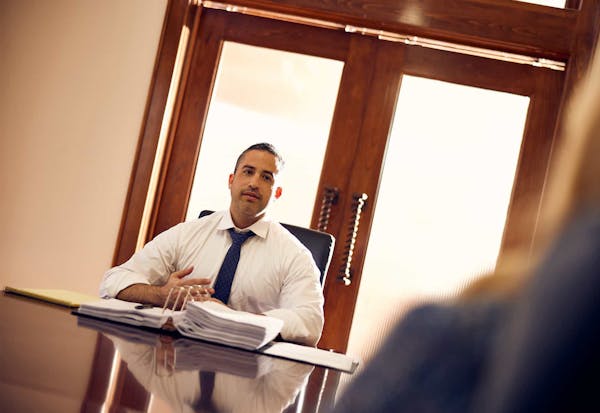 Brain Gutierrez sitting at a table with a client