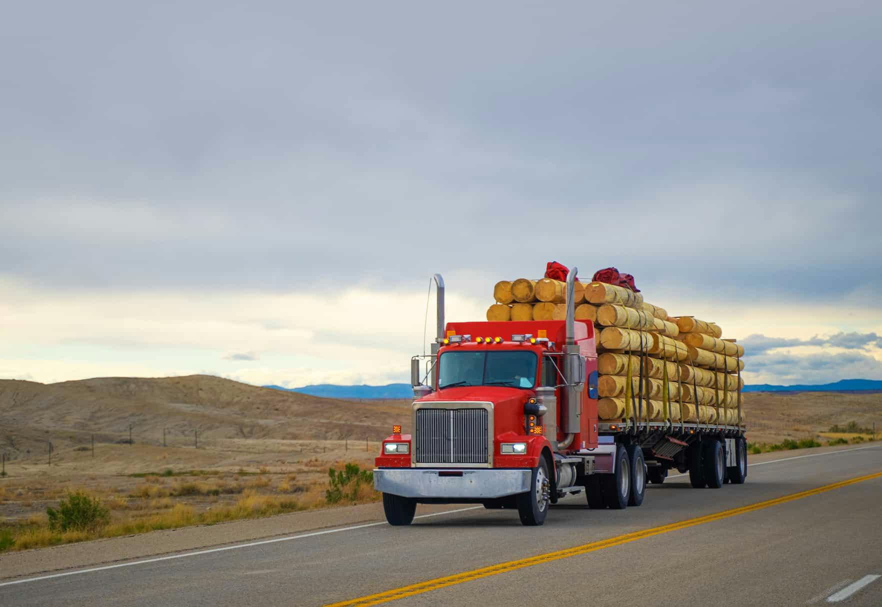 A logging truck driving down the freeway