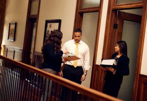 Brian Gutierrez talking with legal assistants