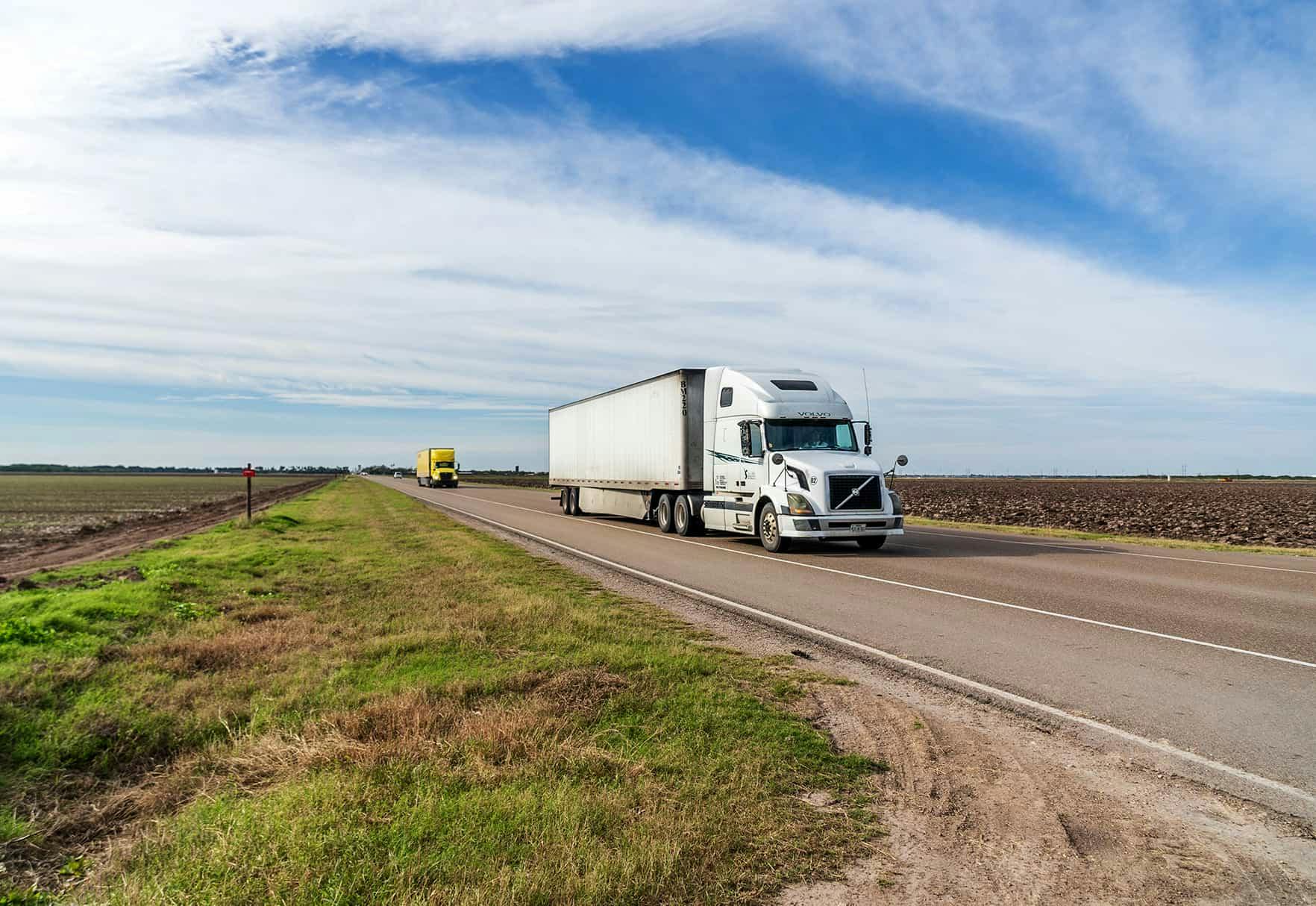 A semi-truck driving down the freeway