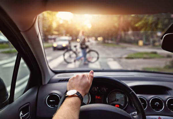 Drivers view of a crosswalk filled with pedestrians