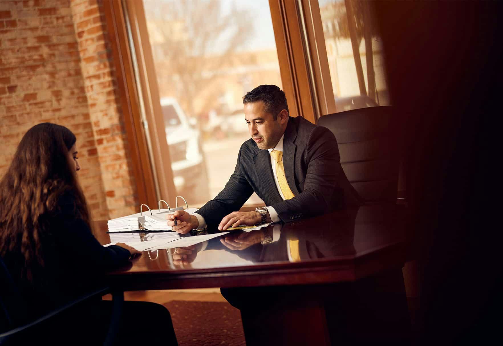 Brian Gutierrez sitting with a client