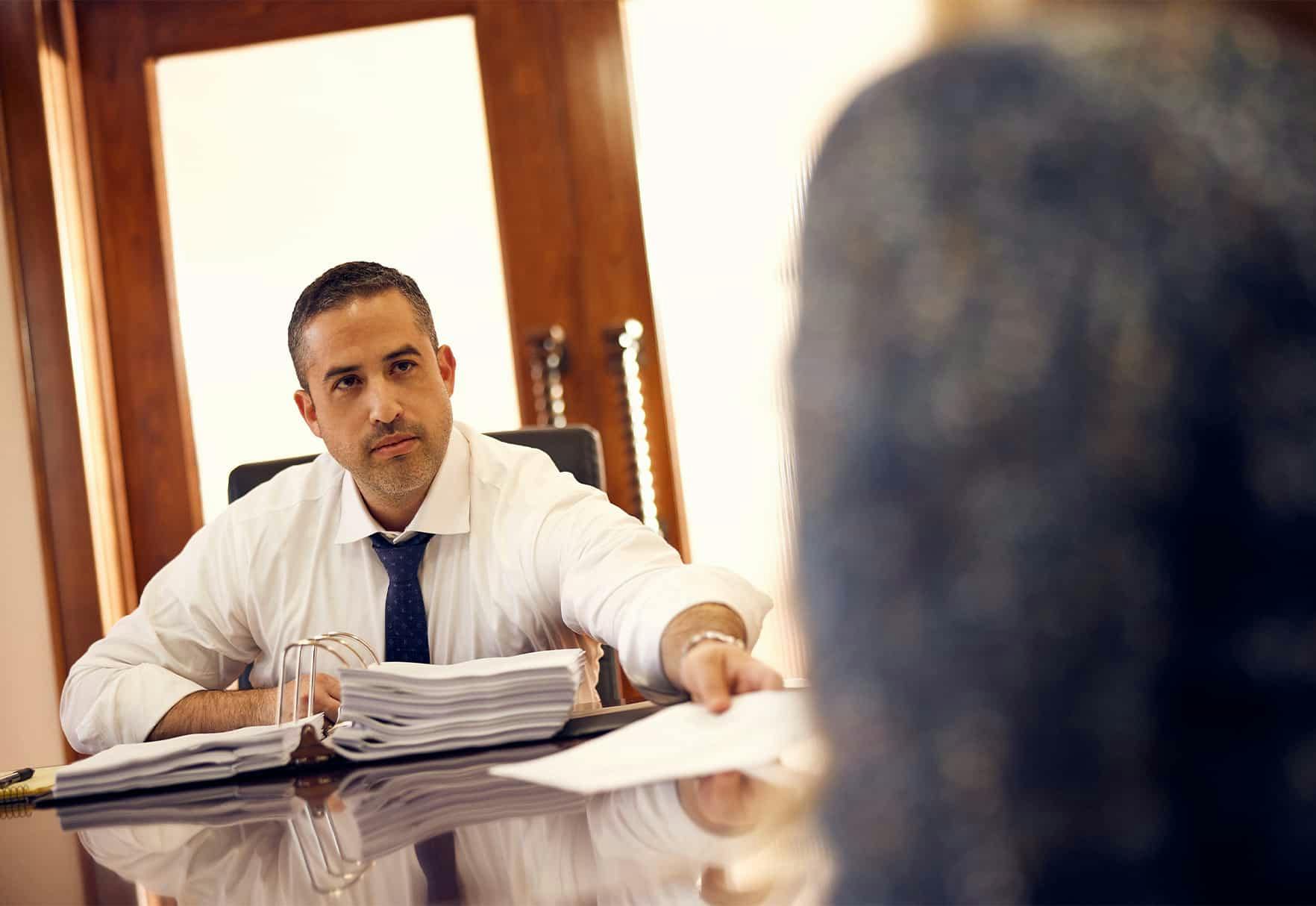 Brian Gutierrez sitting at a table with a client