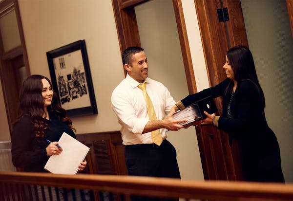 Brian Gutierrez handling a legal binder