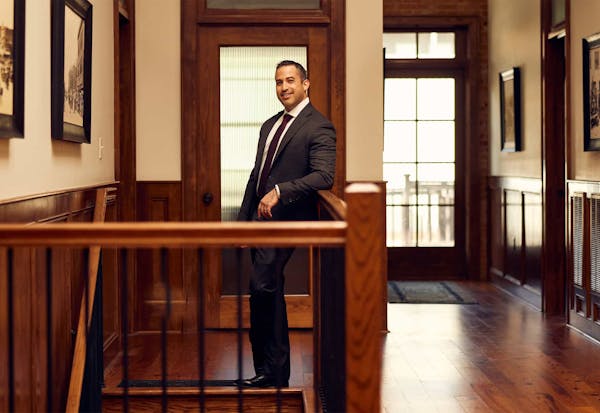 Brian Gutierrez standing by a staircase